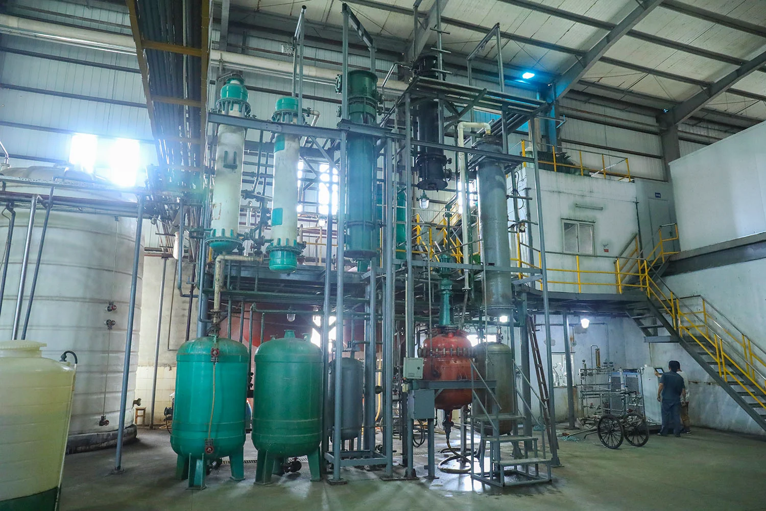 Production equipment and pipework inside a workshop.